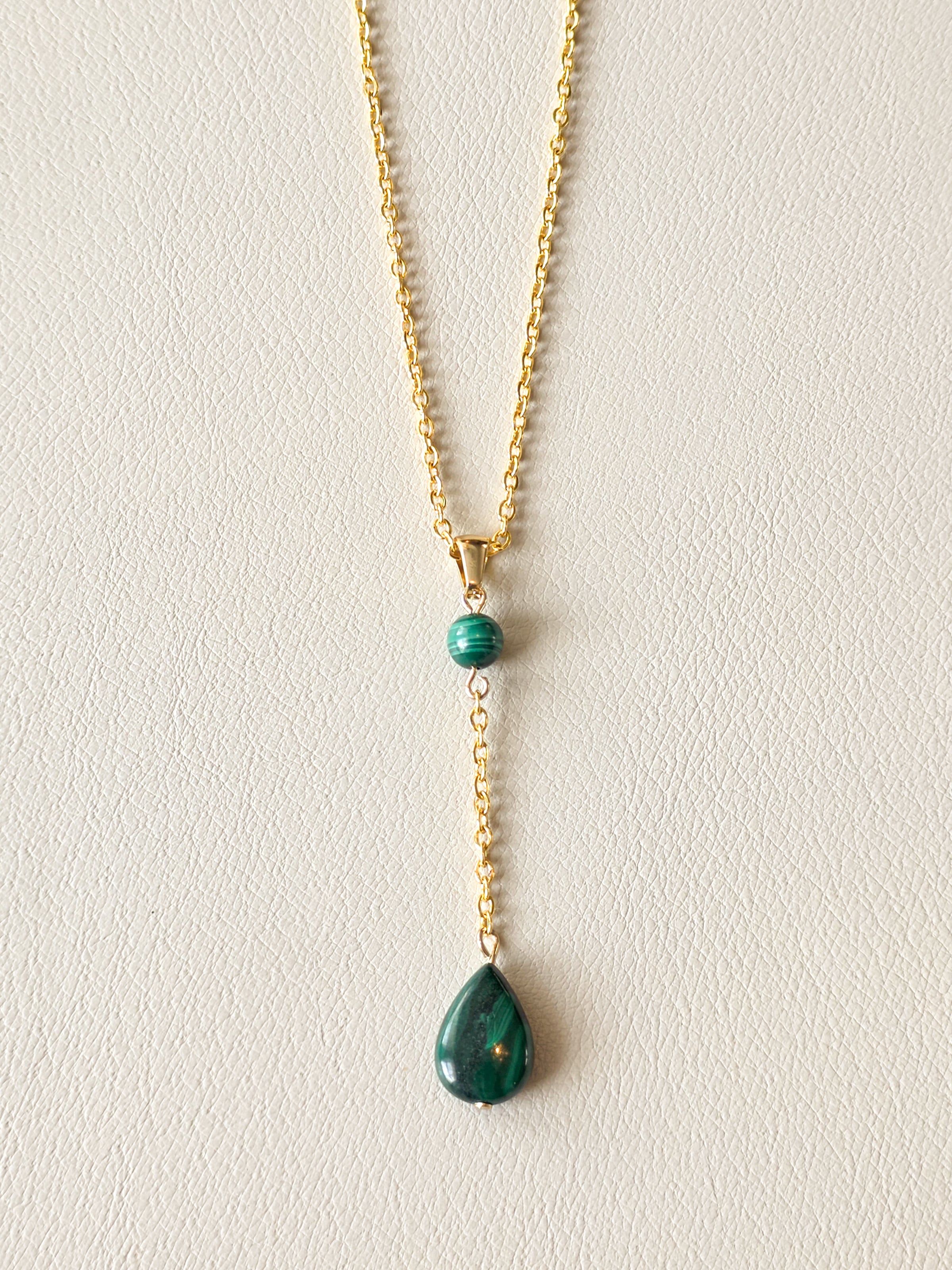 Malachite drop pendant necklace with gold PVD stainless steel chain and polished green stone details.