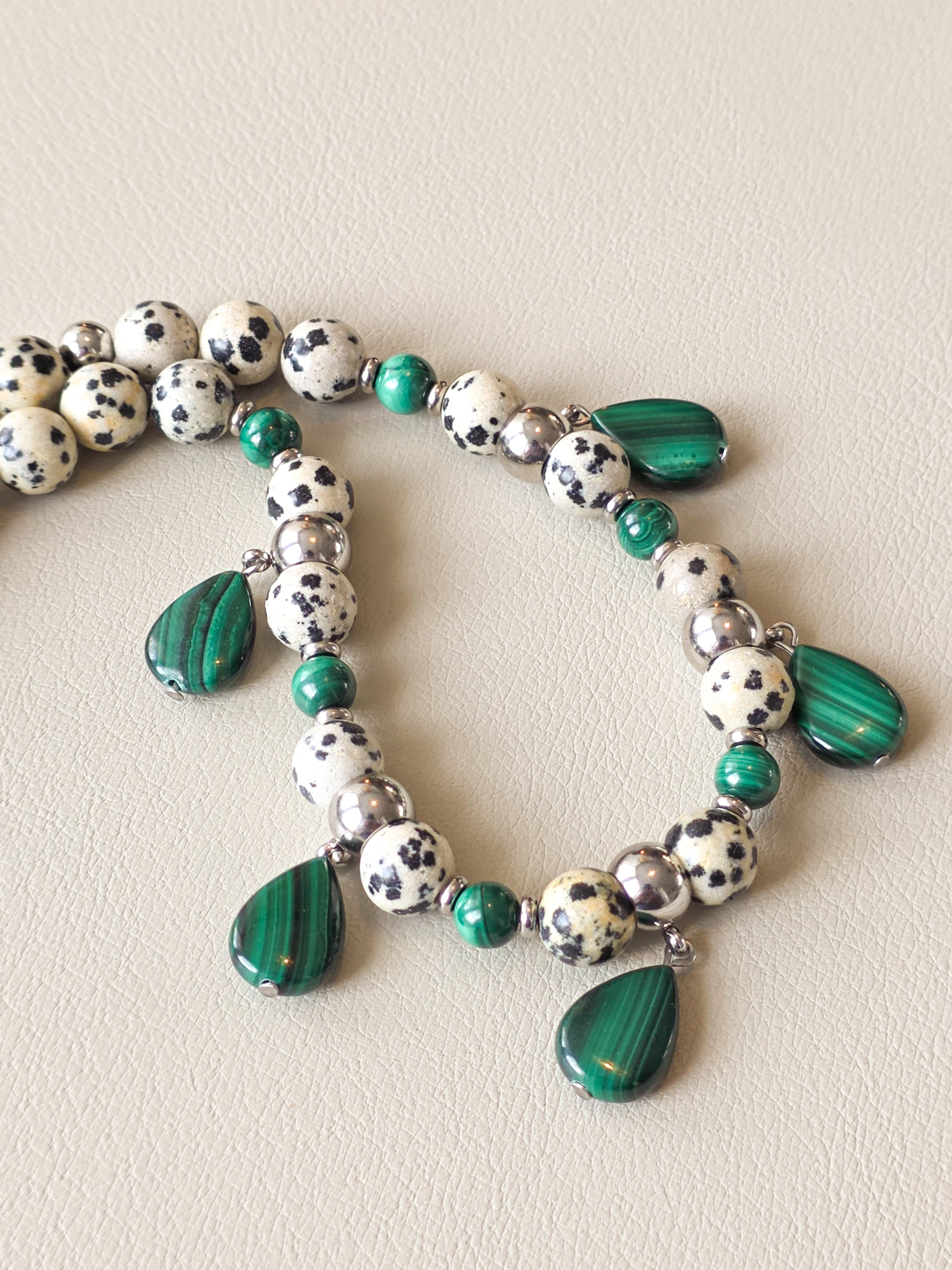 close up view of malachite and dalmatian jasper beaded necklace
